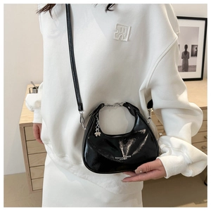 Fashionable black patent leather crescent bag with silver butterfly charm for women