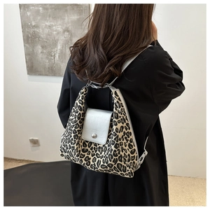 Detail of trendy leopard print backpack with silver grey flap and metallic button