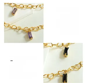 Macro detail of 18K gold plated heart chain bracelet with purple and black zircon charms