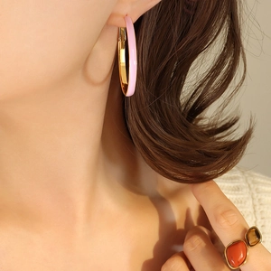 French style gold circle earrings with pink enamel and large stone ring set on model