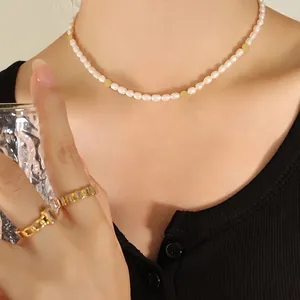 Elegant gold beaded freshwater pearl necklace shown on a model in a lifestyle setting