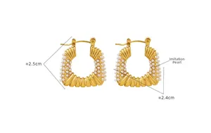 Detailed view of C-shaped golden earrings with faux pearl trim measuring 2.5cm by 2.4cm