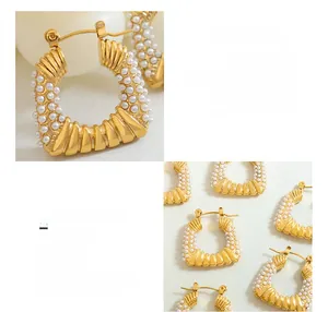 Detail of 18K gold-plated titanium steel U-shaped earrings with faux pearl texture