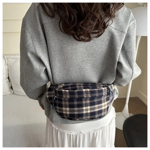 Rear view of a classic British plaid chest bag worn by a model in a cozy home setting