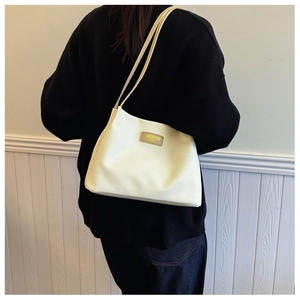 Chic cream waffle texture shoulder bag for women with leather label shown on shoulder
