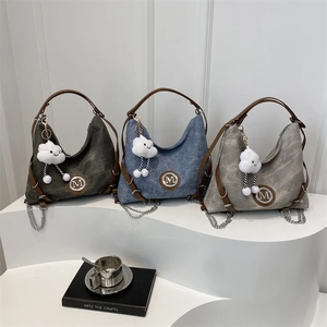 Three minimalist canvas hobo bags in green blue and grey with leather straps and cloud charms