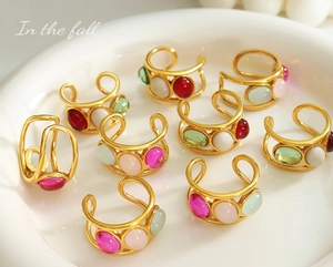 French vintage colorful beaded ear cuffs on a white ceramic plate for girls