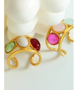 Detail of vintage gold-plated open rings with colorful oval cabochon gemstones