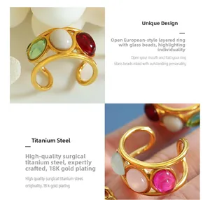 Detail of 18K gold plated titanium ring with colorful glass beads on a stone