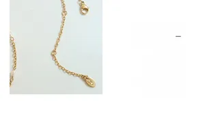 Dettaglio della chiusura a moschettone e targhetta in oro 18K su collana di perle