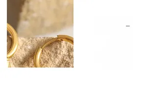 Detail of 18K gold plated stainless steel hoop earring hinge on natural stone surface