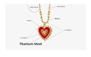 Detail view of red heart pendant necklace showing dimensions and brass chain texture
