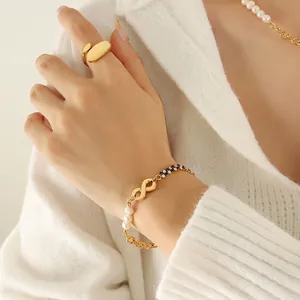 Elegant gold bracelet with infinity charm, pearls and black-white zircon cuban chain
