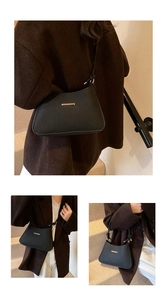 Detail showing herringbone texture and gold hardware on black crescent shoulder bag