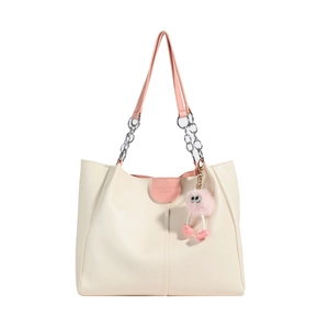 Chic beige tote bag with pink leather straps, silver metal chains and cute monster charm