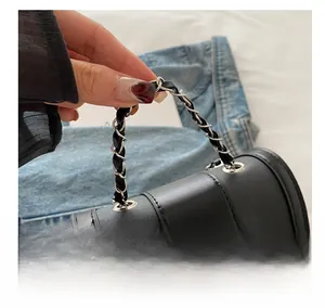 Close-up of black crossgrain leather handbag with trendy black and silver chain handle