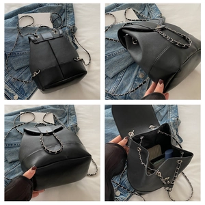 Detail views of black leather backpack with chain straps from back side and interior