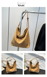 Detail of khaki suede tote bag showing soft texture and knotted strap craftsmanship