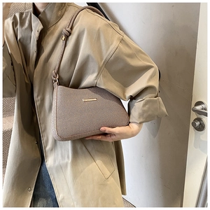 Detail showing vintage twill fabric texture and rope knot shoulder strap on the bag