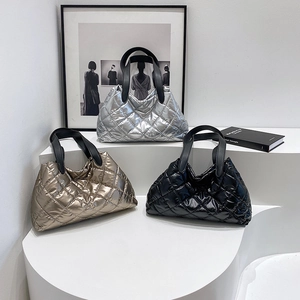 Quilted metallic puffer tote bag set in silver, gold, and black with leather handles