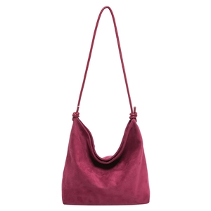 Minimalist burgundy suede hobo tote bag featuring a knotted shoulder strap and soft texture
