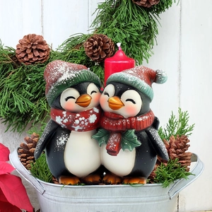 Christmas penguin couple garden stakes in metal bucket with candle and winter pine decor
