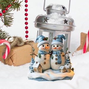 Detailed Christmas snowman scene featuring figurines and a glowing wooden house miniature