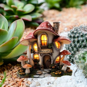 Detail of miniature mushroom house with glowing LED lights and Welcome sign in a garden