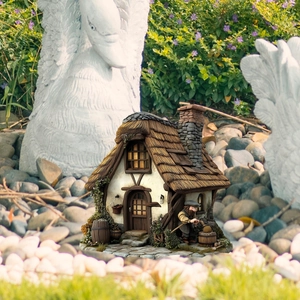 Detailed garden miniature mushroom house with fairy tale stone chimney and garden stakes