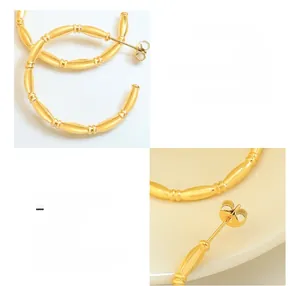 Macro detail of 18K gold plated C-shaped earrings with unique bamboo texture design