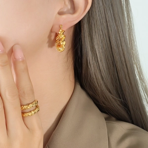 French style gold twisted C-shape earrings and ring set with elegant lava texture finish