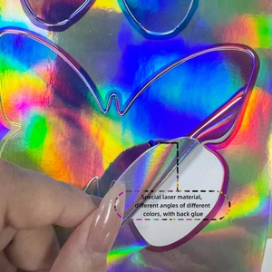 Detail view of iridescent laser butterfly sticker showing adhesive backing and color change