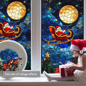 Close-up of static Christmas window decals with Santa Claus sleigh and stars on glass