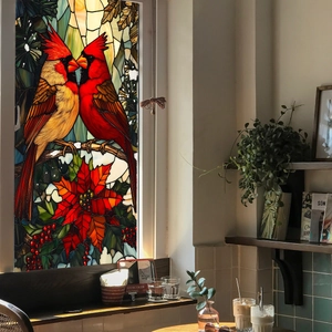 Detail of cardinal birds and poinsettia flowers on a stained glass window static cling