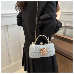 Détail de la pochette de soirée à paillettes bleu clair avec fermoir fleuri en strass