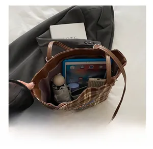 Internal view of the brown checkered tote bag showing large capacity for tablet and umbrella