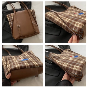 Detail view of brown plaid tote with colorful caterpillar embroidery and metal zippers