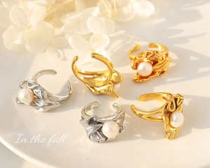 Detailed view of organic petal-shaped titanium steel rings with freshwater pearls
