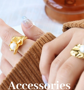 Detailed view of irregular gold titanium ring with a white freshwater pearl on hand