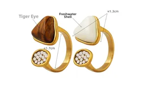 Detail showing tiger eye and freshwater shell rings with gold plating and zircons