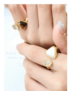 Detailed close-up of a gold-plated titanium steel ring with tiger eye and shell inlay