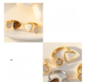 Detail of 18K gold plated titanium rings featuring tiger eye and freshwater shell stones