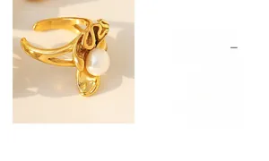 Detailed view of gold irregular wavy ring featuring a lustrous round white pearl inlay
