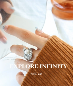 Detail of silver irregular lava ring with white pearl on a corduroy fabric background
