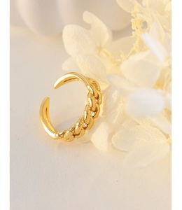 Detail of golden Cuban chain ring with smooth asymmetric band on white background