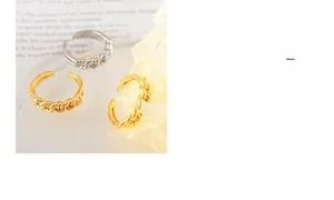 Detail of adjustable gold and silver Cuban chain rings with a minimalist metal design