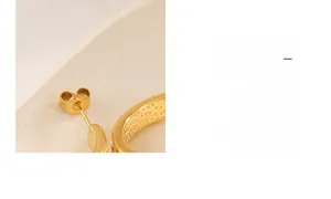 Detailed macro view of the gold-plated butterfly ear nut and textured C-shape design