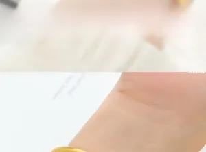 Detail of 18K gold plated titanium steel bangle showing matte finish on a wrist