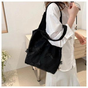 Detail of floral butterfly embroidery on double-layer black lace tote shoulder bag