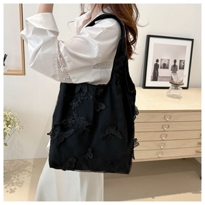 Detail of black lace tote bag with 3D butterfly embroidery and spacious design